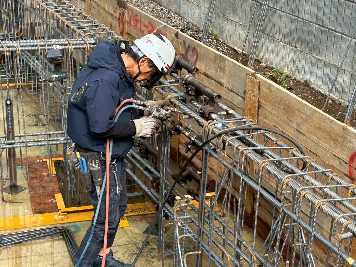 基礎鉄筋の継手作業を行う作業員